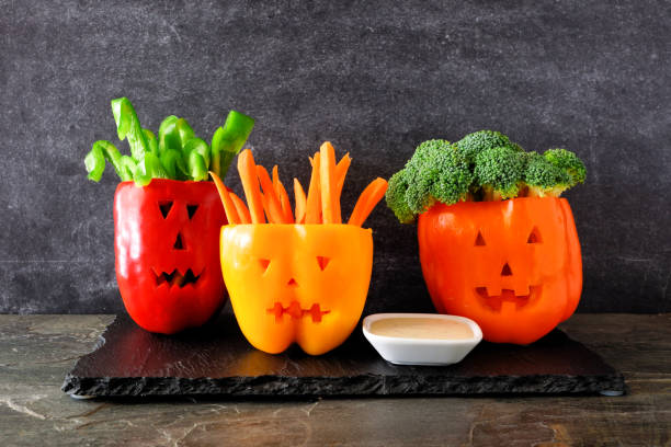 istock Halloween vegetables and dip in Jack o Lantern peppers on a dark background 1039099460