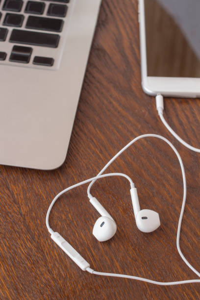istock Business concept: Phone with headphones on the table. Close-up 1039100878