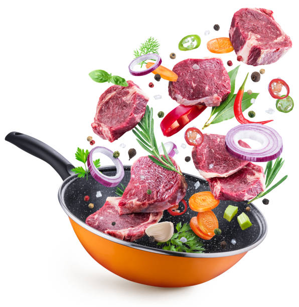 istock Flying meat steaks and spices over a pan. 1039118064