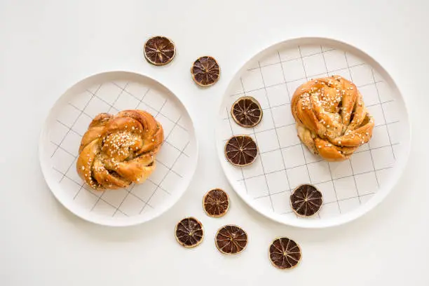 Traditional Scandinavian cardamom buns decorated with dried lemon slices.