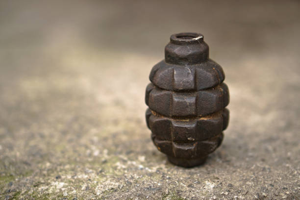 Neutralized grenade of the Second World War on a concrete background of a bunker. Dangerous artifacts of history. Stock Photo stock photo