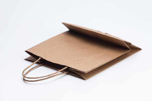 istock Brown kraft paper shopping bag lying on white 1039132038