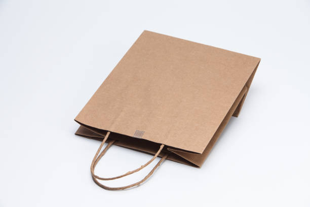 istock Brown kraft paper shopping bag lying on white 1039132092