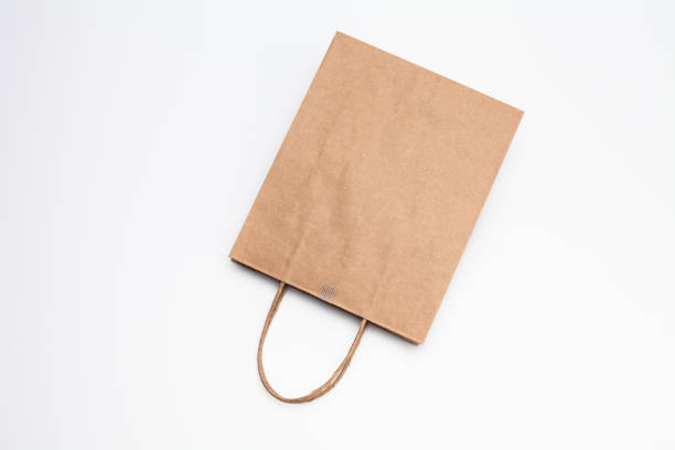 istock Brown kraft paper shopping bag lying on white 1039132150