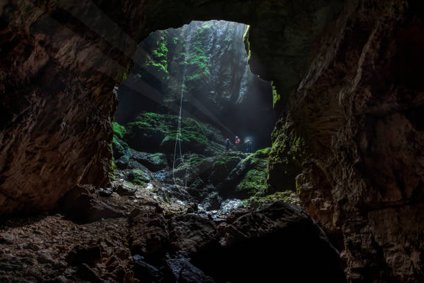istock cave landing with rope and adventurous cave team 1039132502