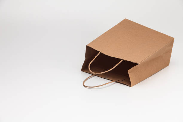 istock Empty open brown craft paper shopping bag lying on white 1039132862