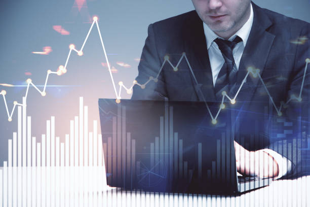 istock businessman with laptop and business chart 1039141384