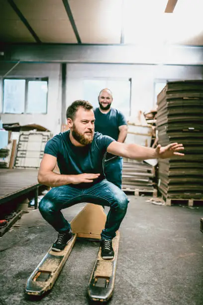 Photo of Young Warehouse Guys Have Fun at Work