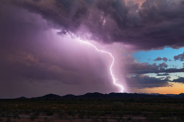 istock Lightning bolt strikes from a storm cloud at sunset. 1039163636