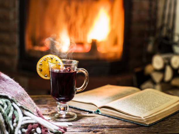 istock Hot mulled wine and a book on the wooden table. 1039164016