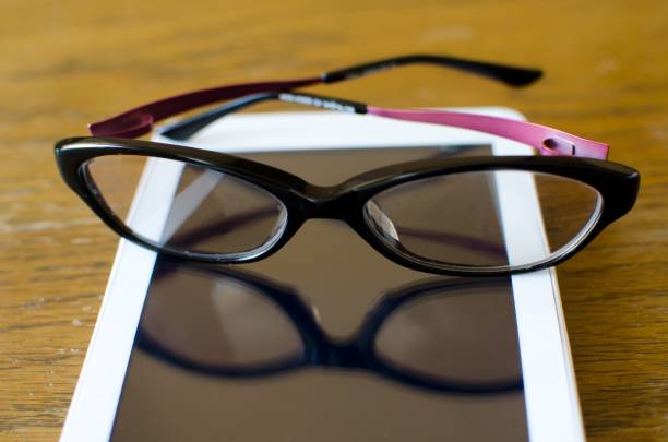 istock modern black pink eyeglasses on white tablet with reflection 1039164190