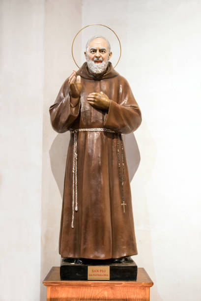 Statue of Padre Pio or Saint Pio of Pietrelcina Noto, Sicily, Italy - August 20, 2018 : Statue of Padre Pio or Saint Pio of Pietrelcina inside Noto's Cathedral, Sicily, a Roman Catholic friar and priest who displayed Holy Stigmata throughout his life, with his hand raised in benediction beatification stock pictures, royalty-free photos & images