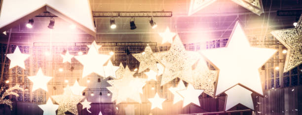 istock Stars spotlights soffits as finest hour celebrity show stage performance background with golden pink lights 1039169698