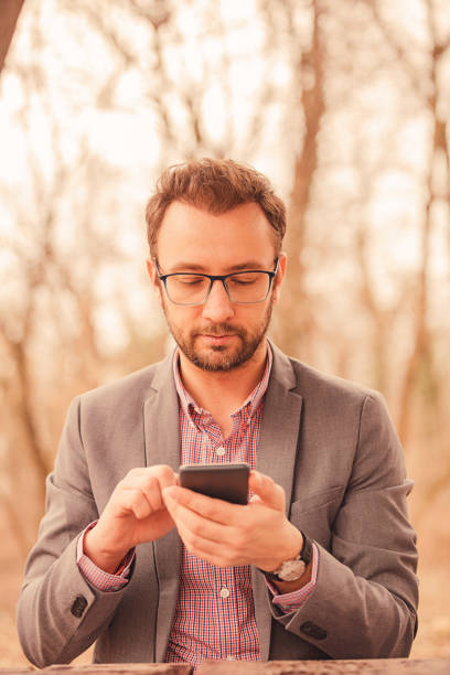 istock Modern business man using cellphone outdoors. 1039182180