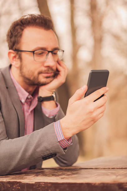 istock Modern business man using cellphone outdoors. 1039184586
