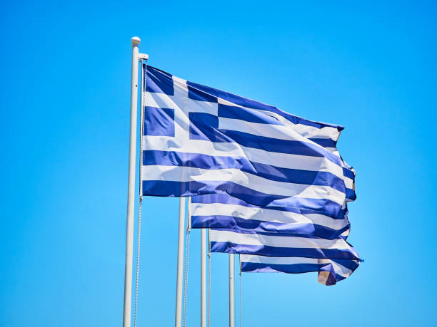 istock Flags of Greece waving on a blue sky. 1039184590