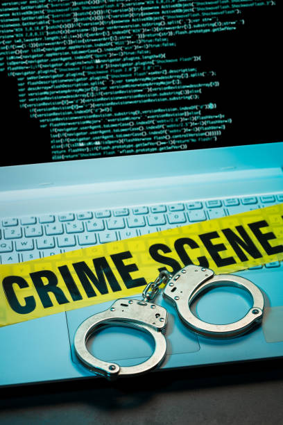Cybercrime Handcuffs on laptop. Cybercrime concept. white collar crime handcuffs stock pictures, royalty-free photos & images
