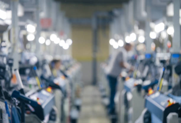 istock Blurry background with weaving loom machines in textile factory 1039198374