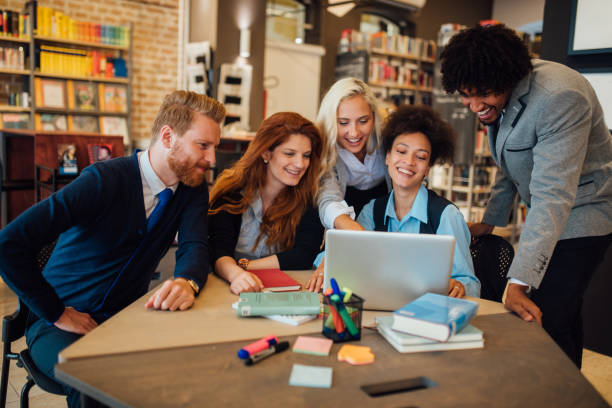 istock Group of students using laptop together 1039198522