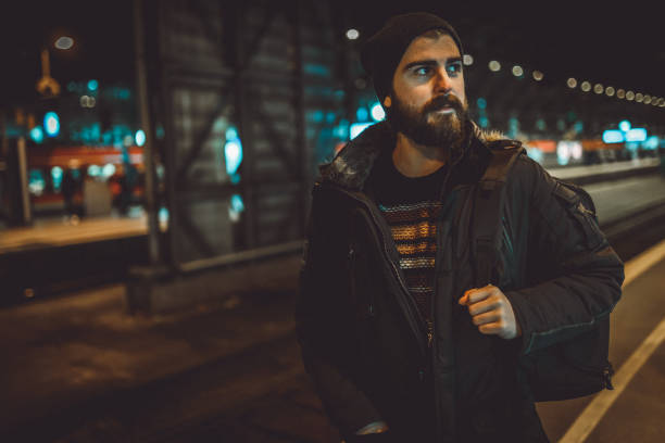 istock Young tourist with a backpack waiting for a train at the train station 1039200084