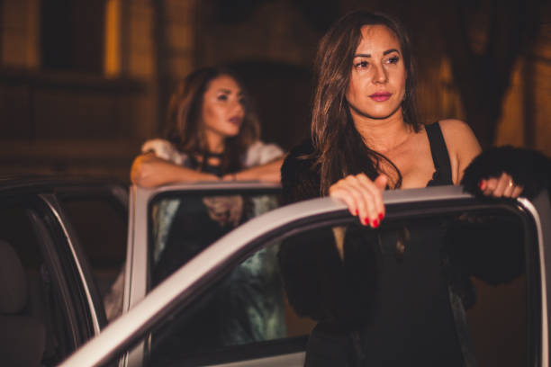 istock Two friends entering a car during their night out 1039203736