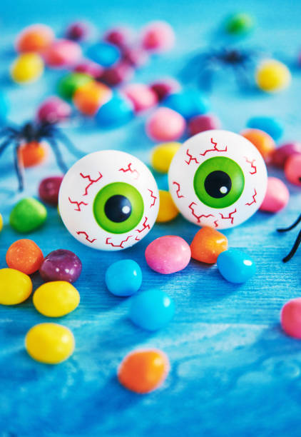 istock Vibrant Halloween background with candy, spiders and eyeballs 1039205122