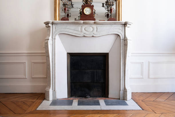 Classic Fireplace in Parisian Home Fireplace in Parisian apartment/home. moulding trim photos stock pictures, royalty-free photos & images