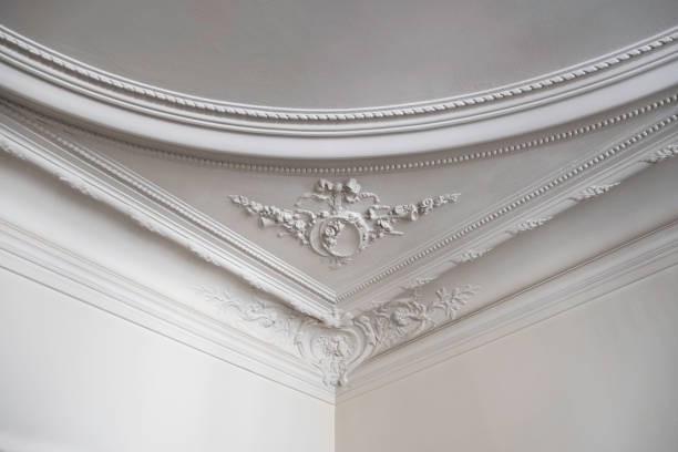 Detailed Ceiling in Luxurious Parisian Home Close up shot of the corner of a ceiling in a luxurious Paris apartment. moulding trim photos stock pictures, royalty-free photos & images