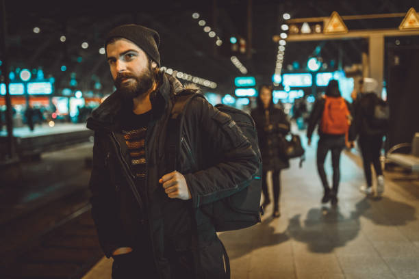 istock Young tourist with a backpack waiting for a train at the train station 1039210066
