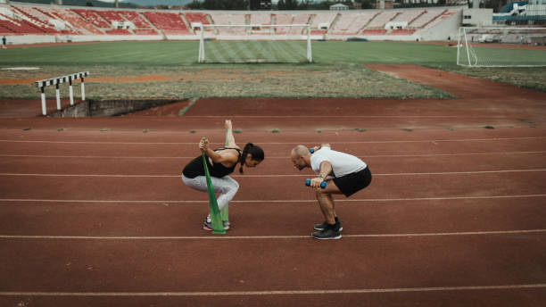 istock Two people exercising on the running track at the stadium 1039218900