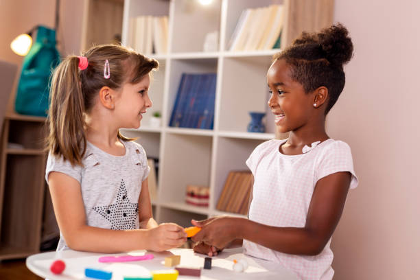 istock Schoolgirls playing with colorful plasticine 1039219830