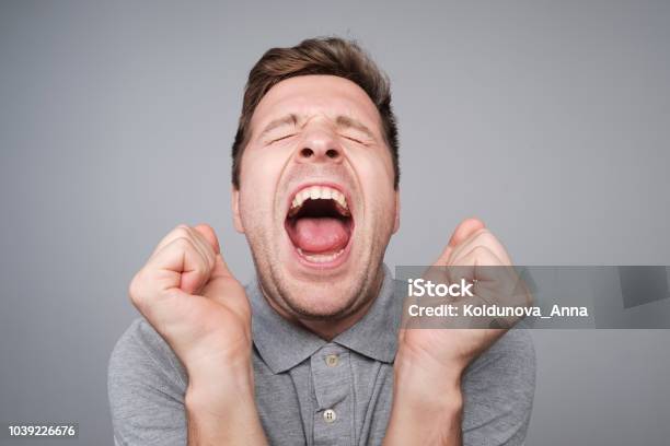 Studio Close Up Shoot Of Adult Man Laughing Looking At The Camera Over White Background Stock Photo - Download Image Now