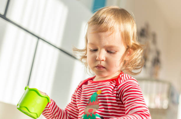 istock cute child sits barefoot on the floor 1039234452