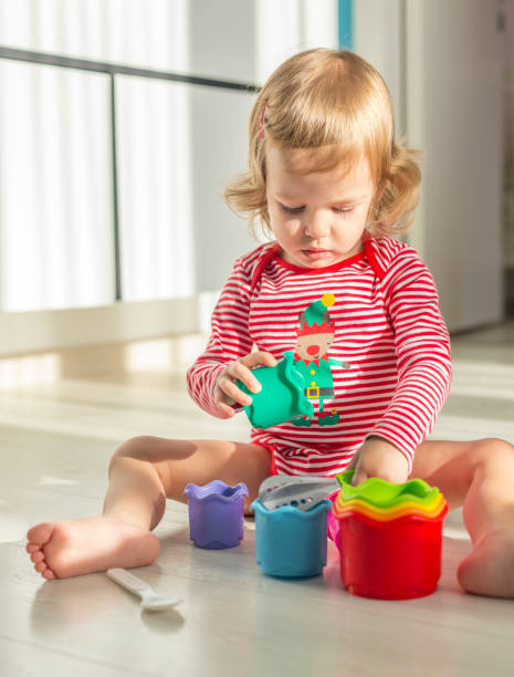 istock cute child sits barefoot on the floor 1039235144