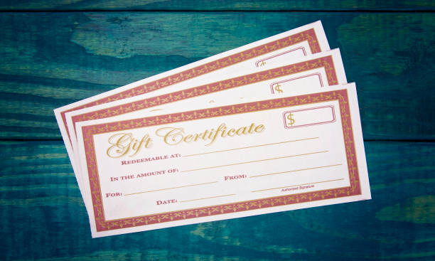 istock Blank Gift Voucher on a Blue Wooden Table 1039268650