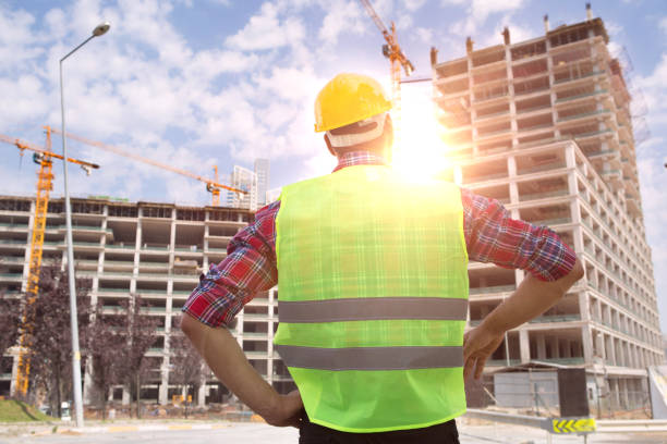 istock Young Engineer portrait with construction site and crane background. 1039269336