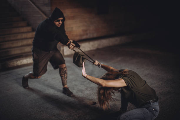 Snatch thief with gun stealing handbag from woman, Robber, Thief concept