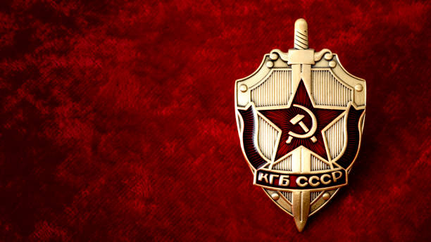 KGB badge on red background with copyspace Secret service, intelligence agency, and espionage concept with cold war era KGB badge from the former USSR, on red background with copy space former soviet union stock pictures, royalty-free photos & images