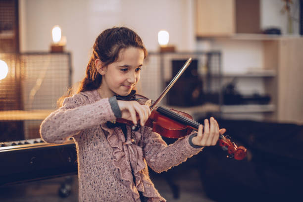 istock Girl teaching to play violin 1039284918