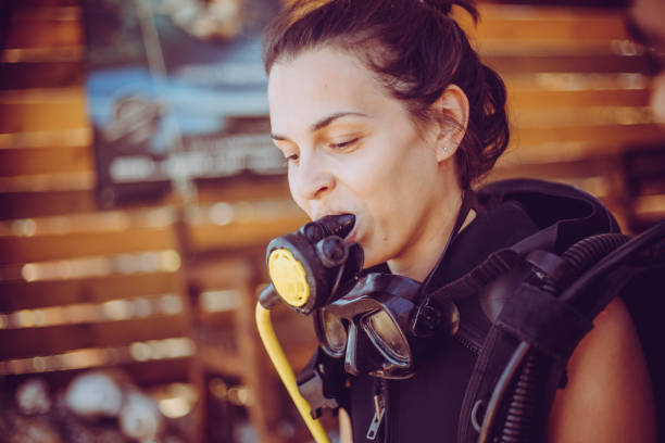 istock Woman prepares diving equipment 1039285840