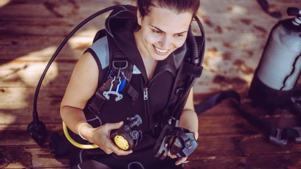 istock Woman prepares diving equipment 1039286246
