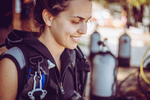 istock Woman prepares diving equipment 1039286382