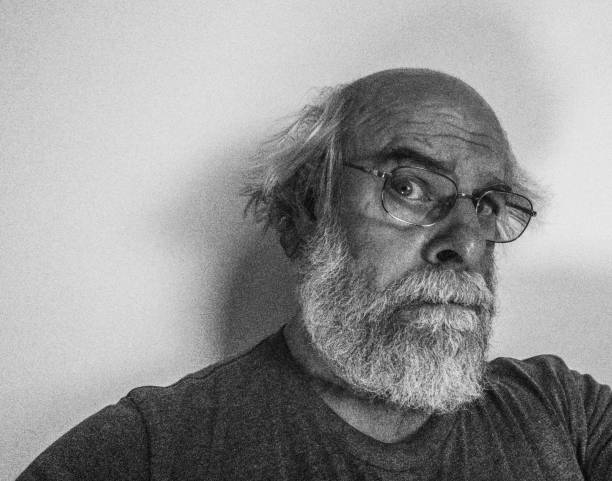 istock Skeptical Senior Adult Man Staring Sideways at Camera 1039293248