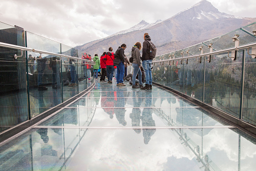 Tourists at the Glacier Skywalk during summer in Jasper National Park, Canadian Rockies, Alberta, Canada.