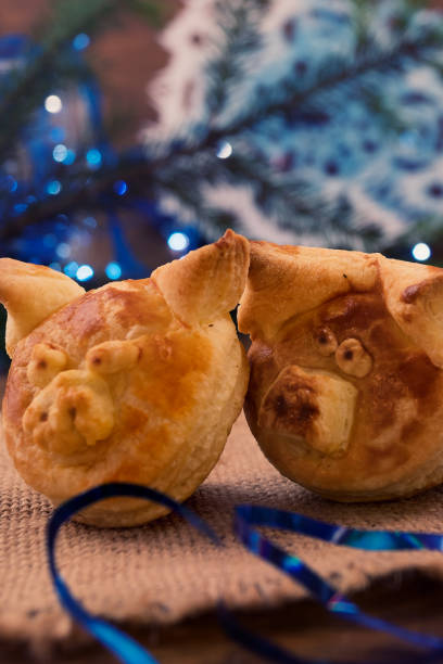 istock Two funny puff pastry pigs next to Christmas decorations, vertical frame. 1039307318
