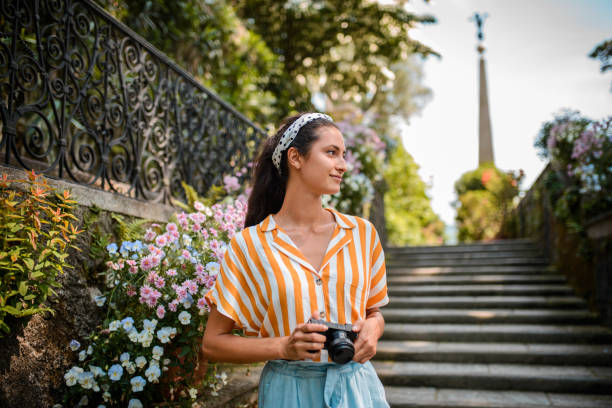 istock Smiling tourist woman with camera. 1039317274