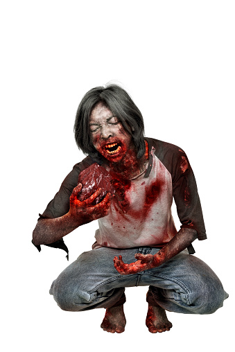 Creepy zombie man eat the raw meat posing isolated over white background