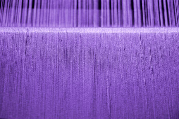 purple cotton yarn on loom for craft texture background