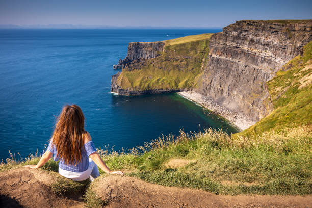 화창한 여름날 동안 절벽 moher 아일랜드에서의 보기를 즐기는 여자 - cliff at the edge of grass sea 뉴스 사진 이미지