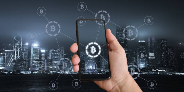 istock Bitcoin cryptocurrency mobile phone payment system network modern city future technology 1039430264